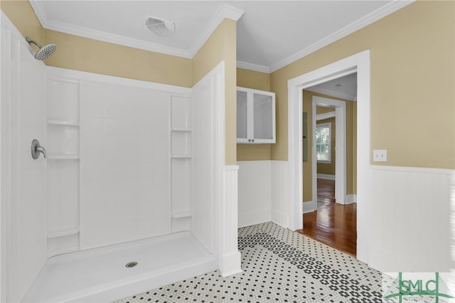 bathroom featuring a shower, hardwood / wood-style floors, and ornamental molding