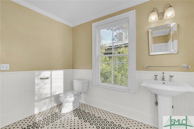 124 Brady St, Savannah, GA 31401 - bathroom with wainscoting, toilet, and ornamental molding