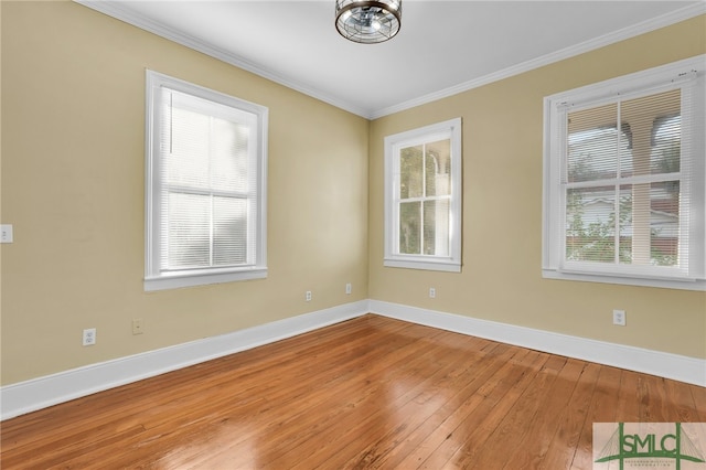 spare room with ornamental molding, hardwood / wood-style floors, and plenty of natural light