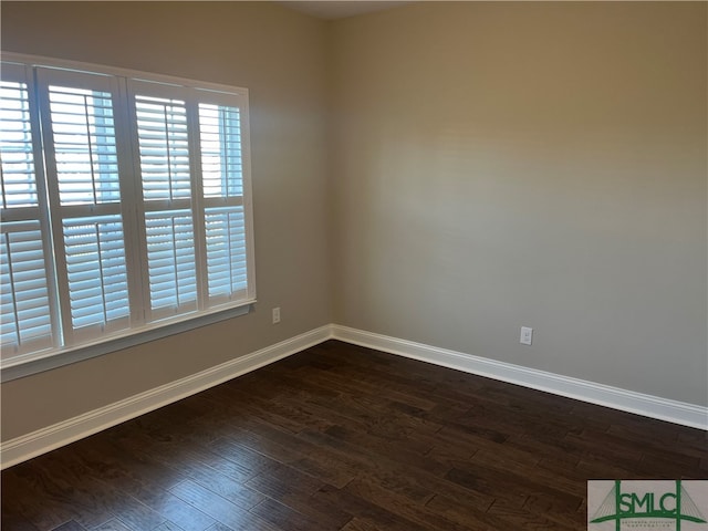 unfurnished room with dark hardwood / wood-style floors