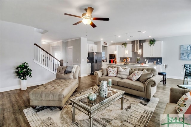 living room with ceiling fan and light hardwood / wood-style flooring