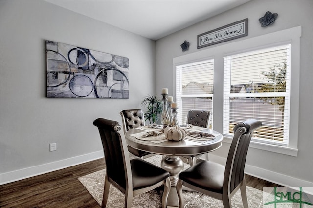 dining area with dark hardwood / wood-style floors