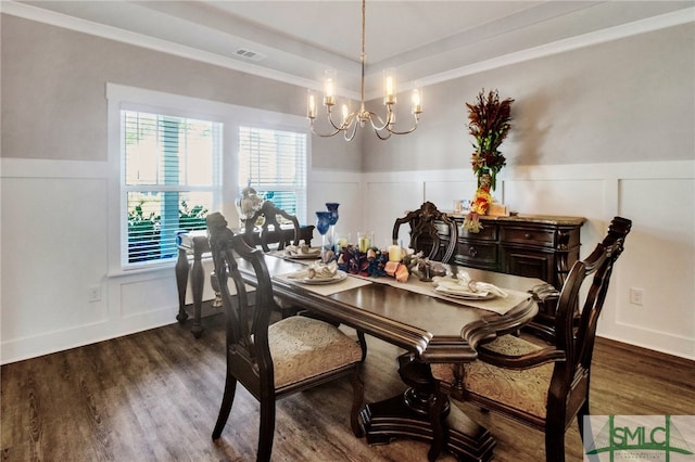 dining area featuring dark hardwood / wood-style flooring and an inviting chandelier