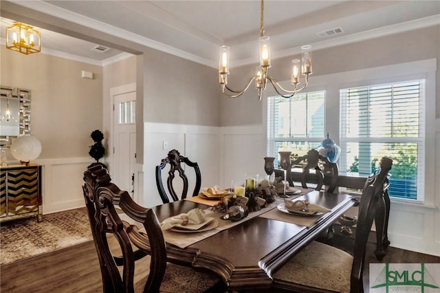 dining room featuring ornamental molding, a chandelier, and dark hardwood / wood-style flooring