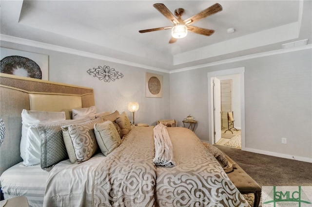 bedroom with connected bathroom, carpet, ceiling fan, and a raised ceiling