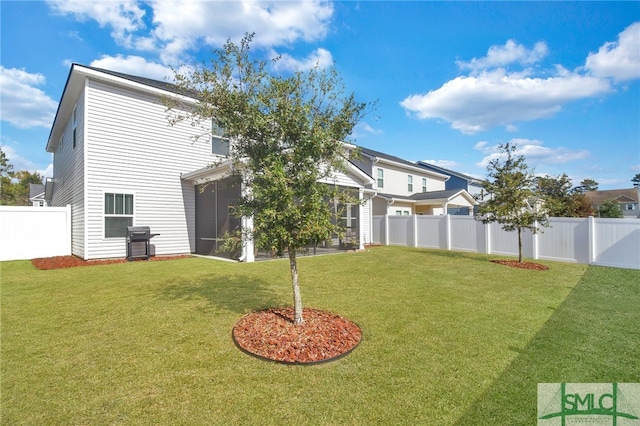 rear view of house featuring a yard