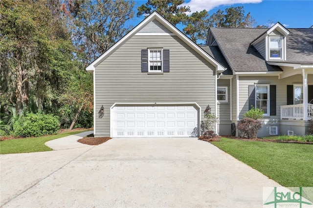 view of front of property with a front yard and a garage