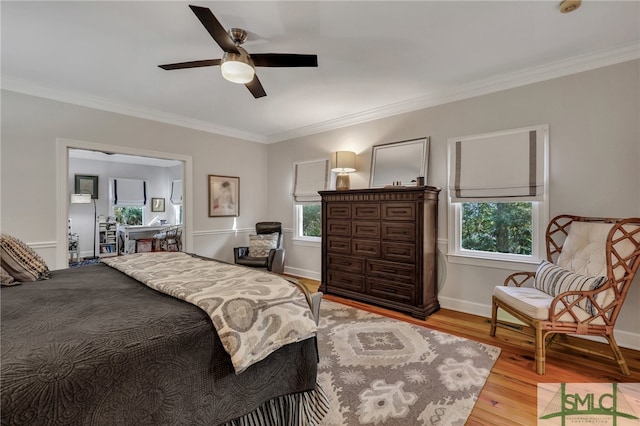 bedroom with ornamental molding, light hardwood / wood-style floors, and ceiling fan