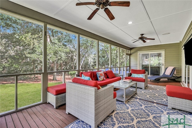 sunroom with a wealth of natural light and ceiling fan