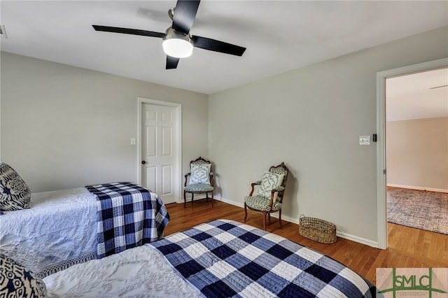 bedroom featuring dark wood-type flooring and ceiling fan