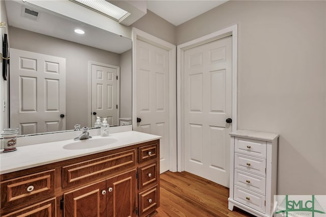 bathroom with vanity and wood-type flooring