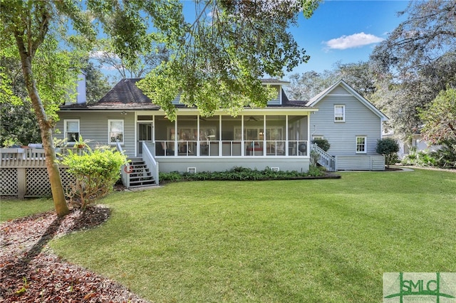 back of property with a lawn and a sunroom