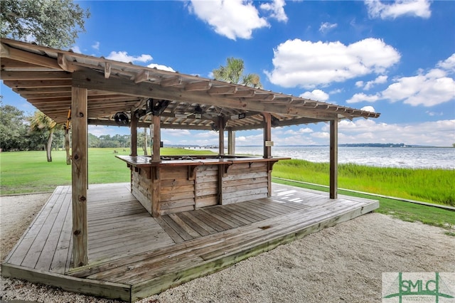 exterior space with a deck with water view and a yard