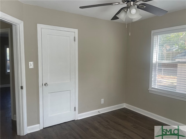 unfurnished bedroom featuring dark hardwood / wood-style flooring and ceiling fan