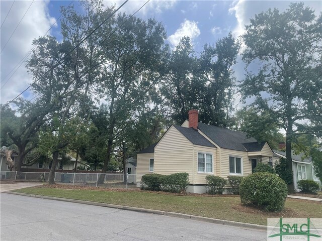 view of side of property with a lawn