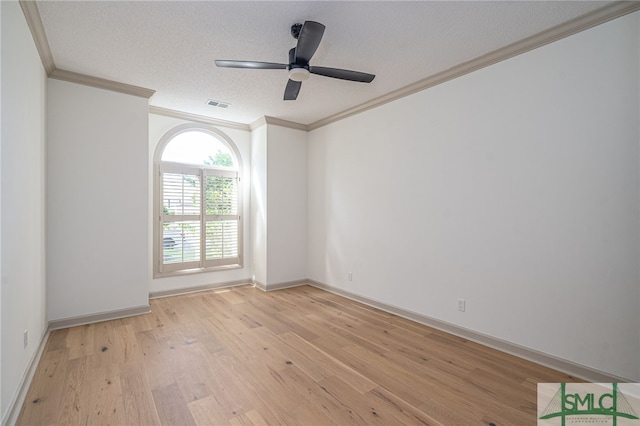 empty room featuring ceiling fan, ornamental molding, a textured ceiling, and light hardwood / wood-style flooring