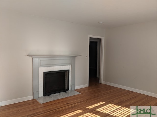 unfurnished living room featuring hardwood / wood-style flooring