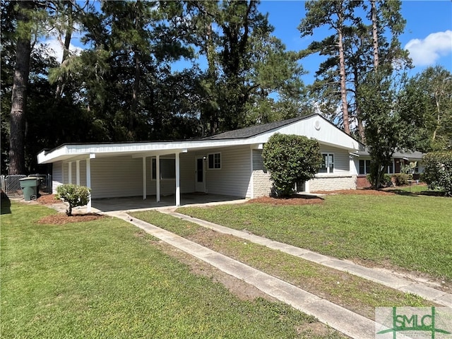 ranch-style house featuring a front yard and a carport