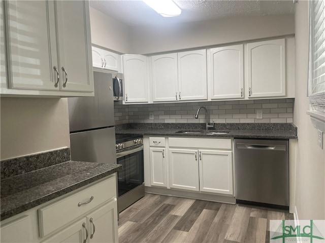 kitchen featuring white cabinetry, stainless steel appliances, sink, and dark hardwood / wood-style flooring