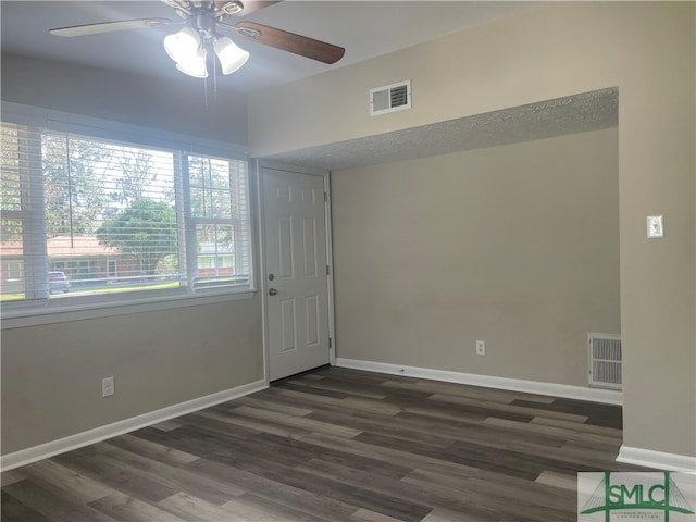 empty room featuring ceiling fan and dark hardwood / wood-style floors