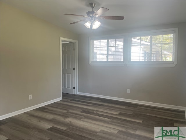 unfurnished room with ceiling fan and dark hardwood / wood-style flooring