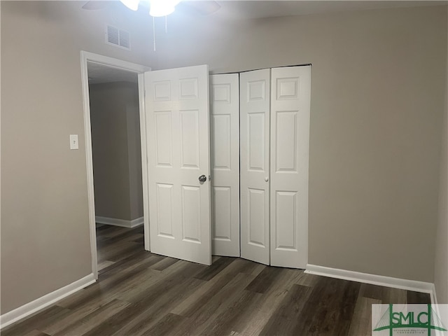 unfurnished bedroom with a closet, ceiling fan, and dark hardwood / wood-style floors