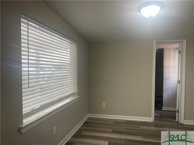 empty room featuring dark wood-type flooring