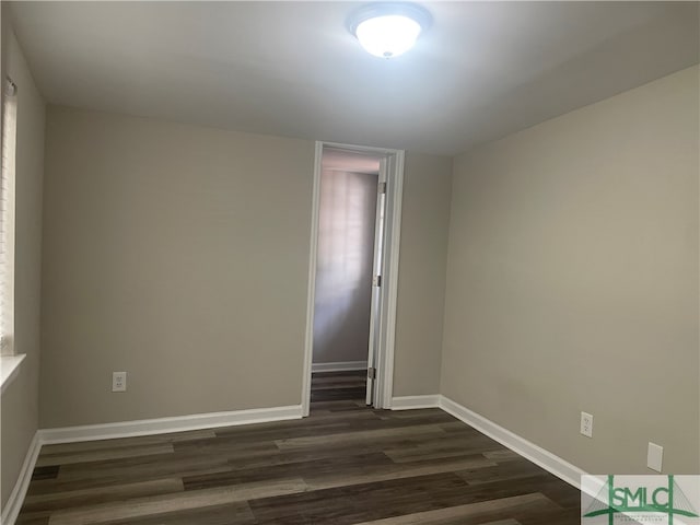 unfurnished room featuring dark hardwood / wood-style flooring