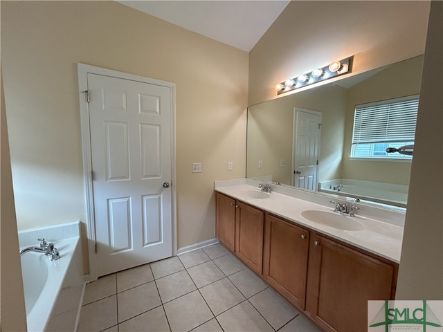 bathroom featuring a bathtub, tile patterned floors, lofted ceiling, and vanity