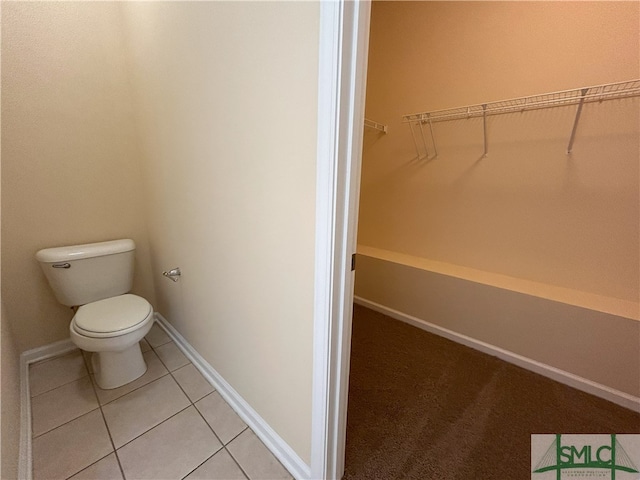 bathroom with toilet and tile patterned floors