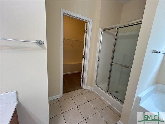 bathroom with vanity, a shower with shower door, and tile patterned flooring