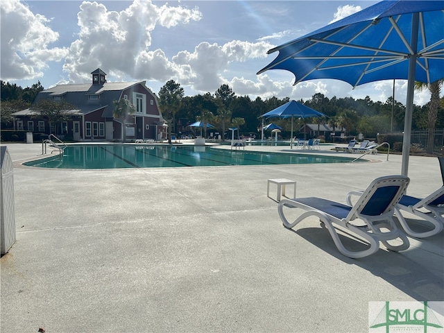 view of swimming pool featuring a patio area