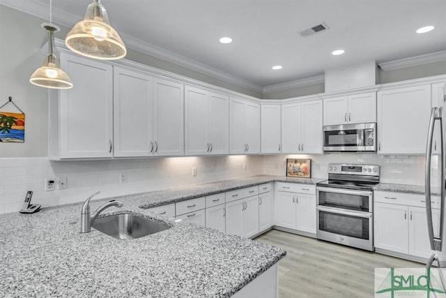 kitchen with sink, appliances with stainless steel finishes, and white cabinetry