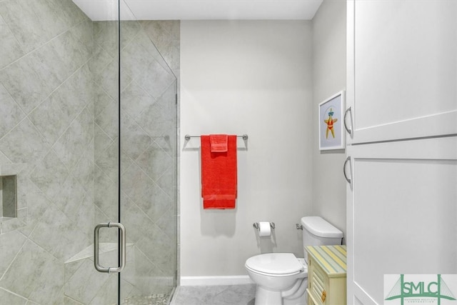 bathroom with toilet, tile patterned floors, and a shower with shower door