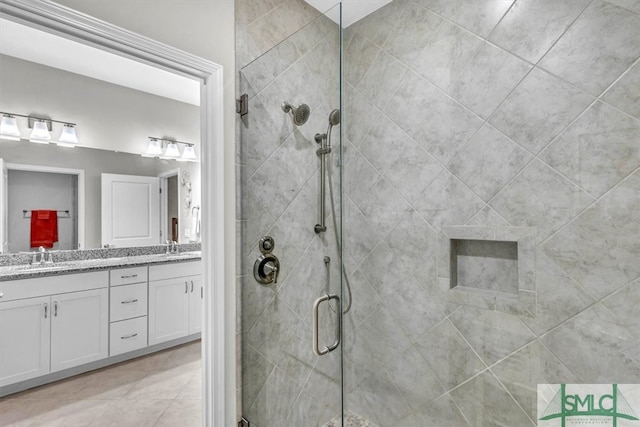 bathroom featuring vanity and a shower with door