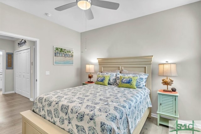 bedroom featuring light hardwood / wood-style flooring, a closet, and ceiling fan