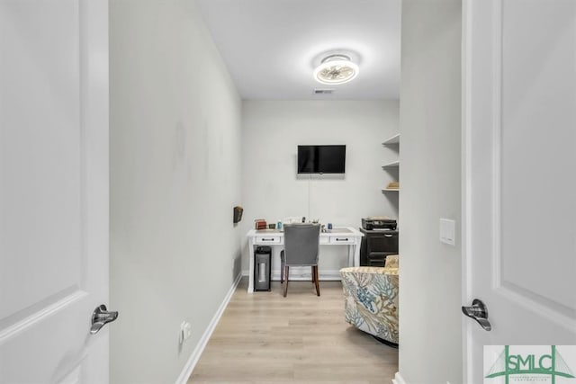 clothes washing area with light hardwood / wood-style floors