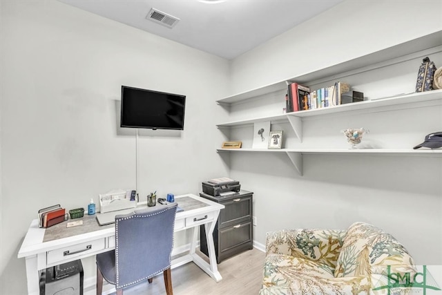 office with light hardwood / wood-style flooring