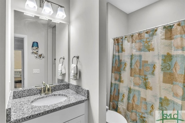 bathroom featuring vanity, toilet, and a shower with curtain