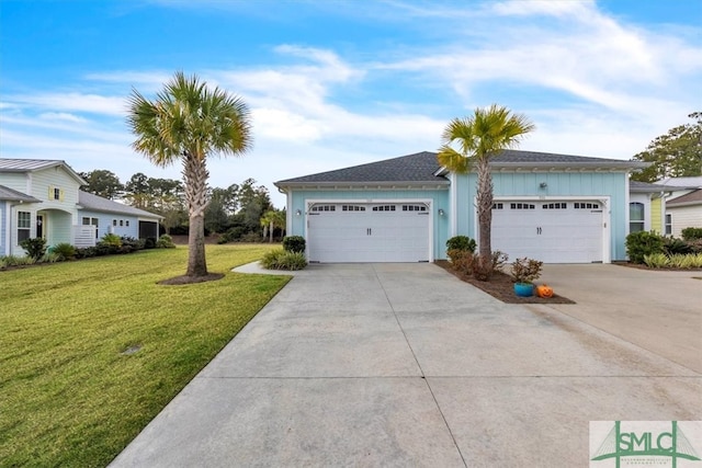 view of front of property with a front lawn and a garage