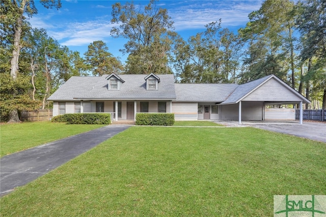 view of front of property featuring covered porch, a carport, a front lawn, and a garage