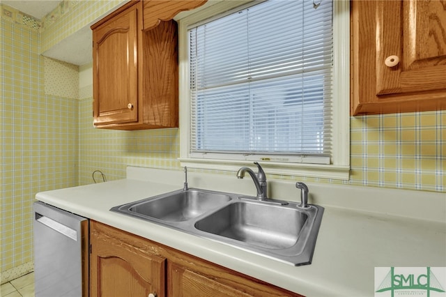 kitchen featuring sink, light tile patterned flooring, and dishwasher