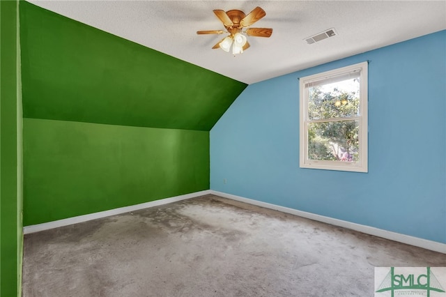 bonus room featuring a textured ceiling, ceiling fan, carpet flooring, and vaulted ceiling