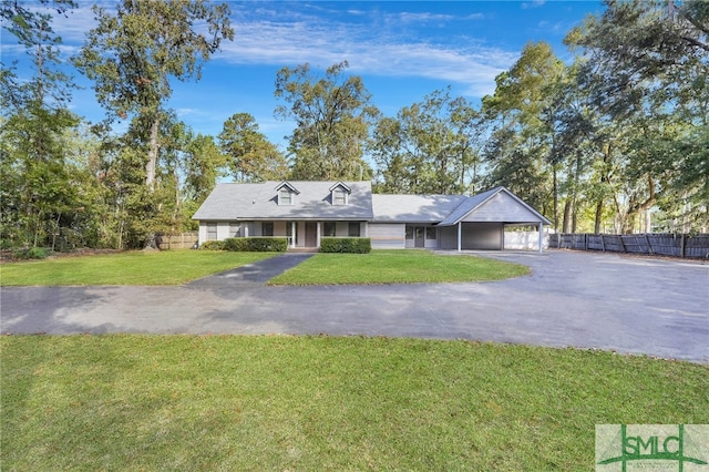 view of front of property with a garage and a front lawn