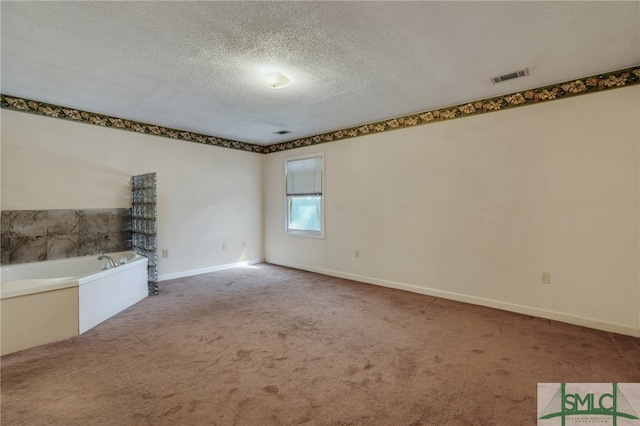 unfurnished living room featuring carpet flooring and a textured ceiling