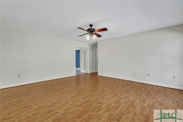 empty room featuring ceiling fan, a textured ceiling, and light wood-type flooring