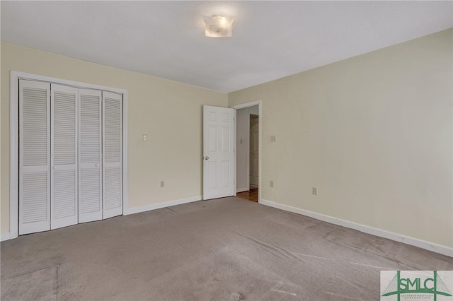 unfurnished bedroom with carpet and a closet