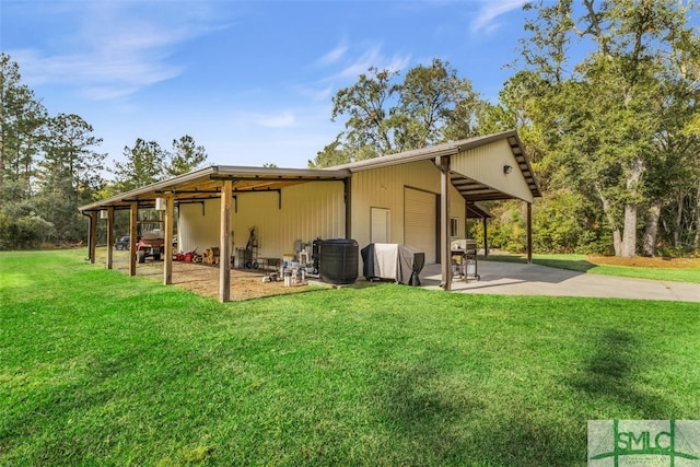 back of property featuring a patio area and a lawn