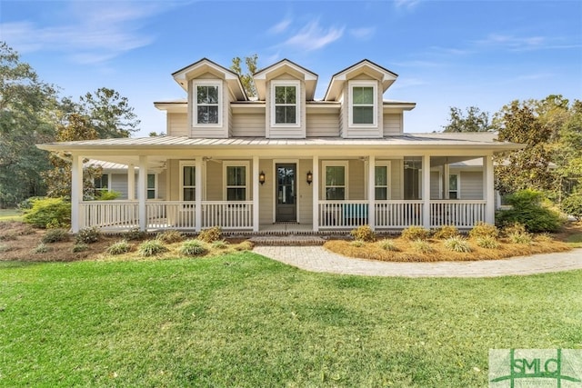 farmhouse with covered porch and a front yard