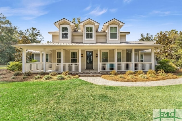 5261 Mill Branch Club Rd, Pembroke, GA 31321 - country-style home featuring a standing seam roof, covered porch, a front yard, and metal roof